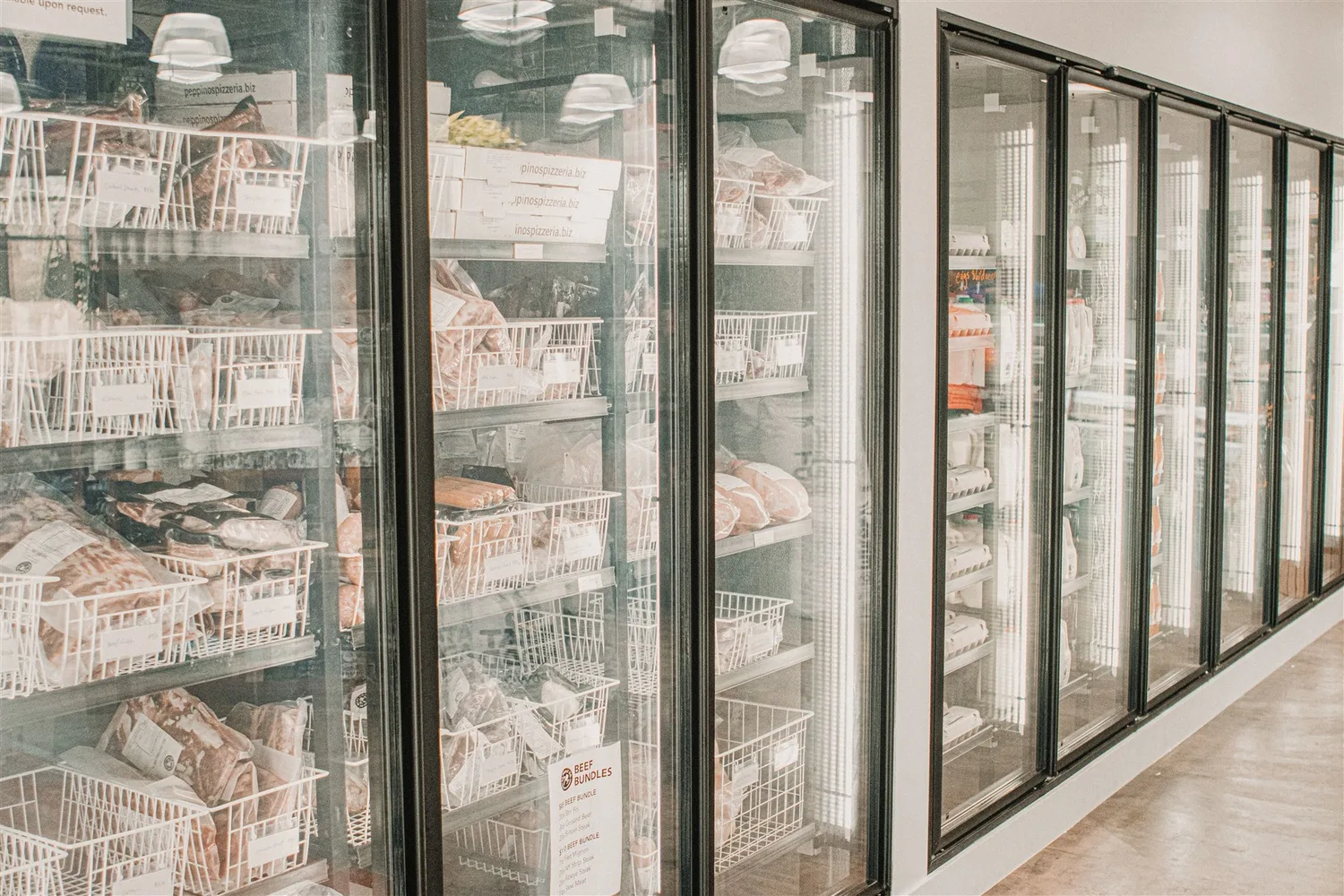 Packaged food arranged in glass-fronted supermarket freezer cabinets